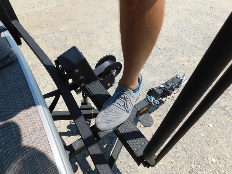 Slide: The Image of Foot on trailer step of 2025 Sun Tracker Fishin' Barge 22 DLX. - 20