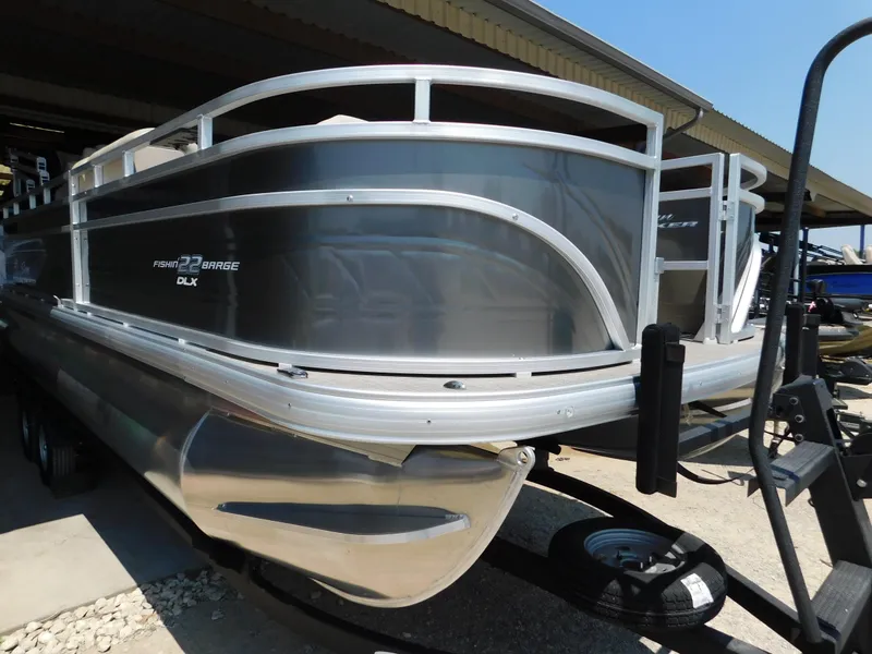 Slide: The Image of 2025 Sun Tracker Fishin' Barge 22 DLX pontoon boat in storage. - 3