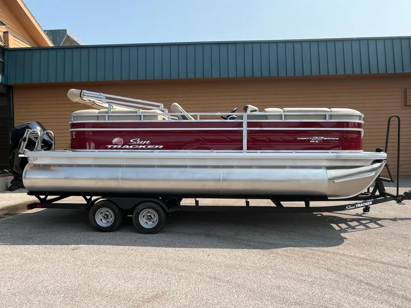 The Image of 2025 Sun Tracker Party Barge 22 RF XP3 pontoon boat on trailer. - 0