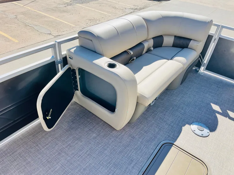 Slide: The Image of 2025 Sun Tracker Party Barge 22 RF XP3 interior with plush seating and storage compartment. - 13