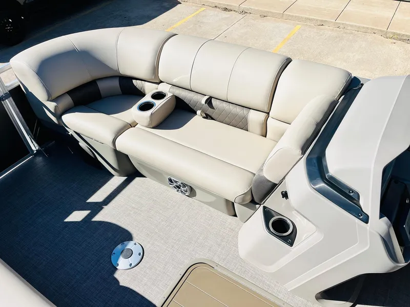 Slide: The Image of 2025 Sun Tracker Party Barge 22 RF XP3 interior with beige seating and cup holders. - 17
