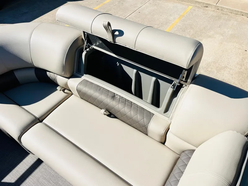 Slide: The Image of Sun Tracker Party Barge 22 RF XP3 2025 seating with storage compartment open. - 19