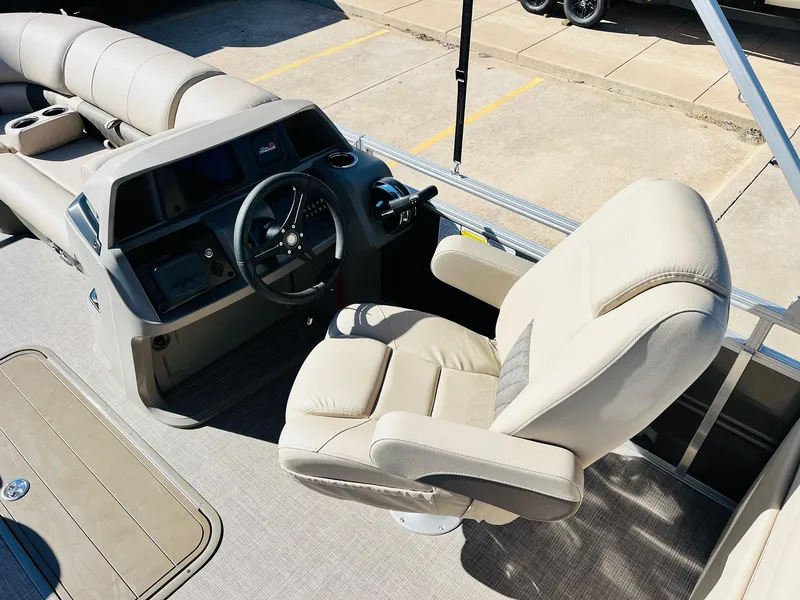 Slide: The Image of 2025 Sun Tracker Party Barge 22 RF XP3 interior with beige captain's chair and steering console. - 30