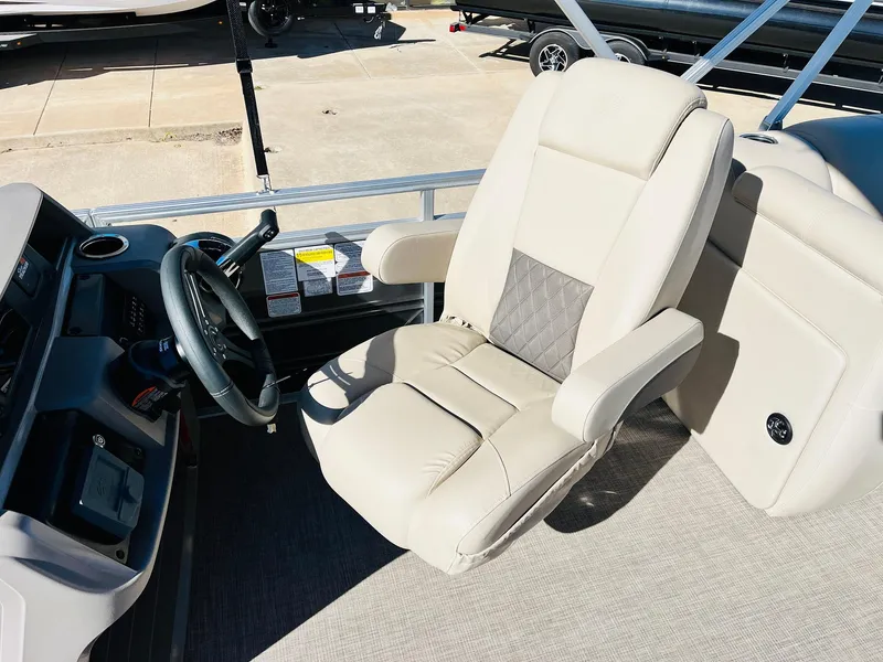 Slide: The Image of 2025 Sun Tracker Party Barge 22 RF XP3 captain's chair and helm, featuring modern design. - 31