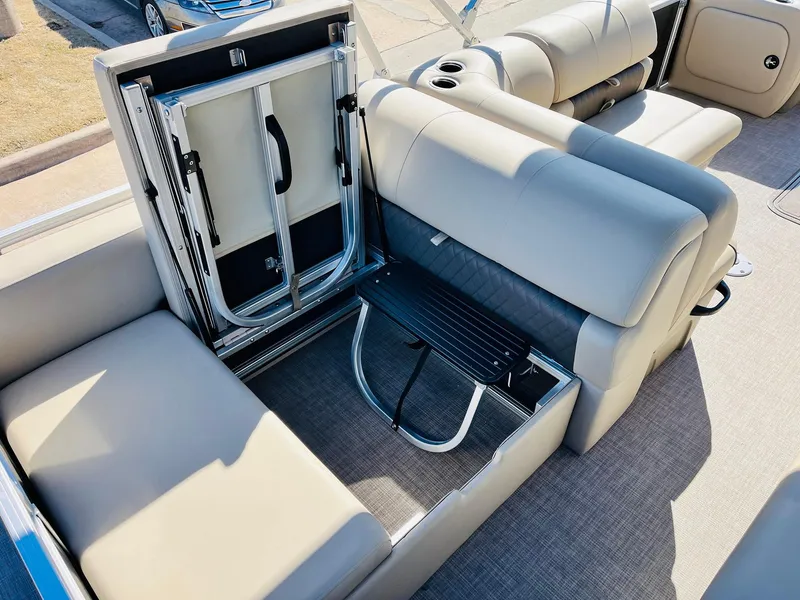 Slide: The Image of 2025 Sun Tracker Party Barge 22 RF XP3 interior seating with storage compartment open. - 43