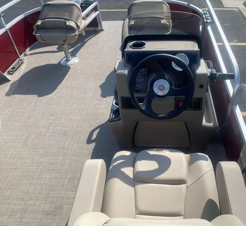 Slide: The Image of 2025 Sun Tracker Bass Buggy 16 XL Select interior with steering console and seating. - 2