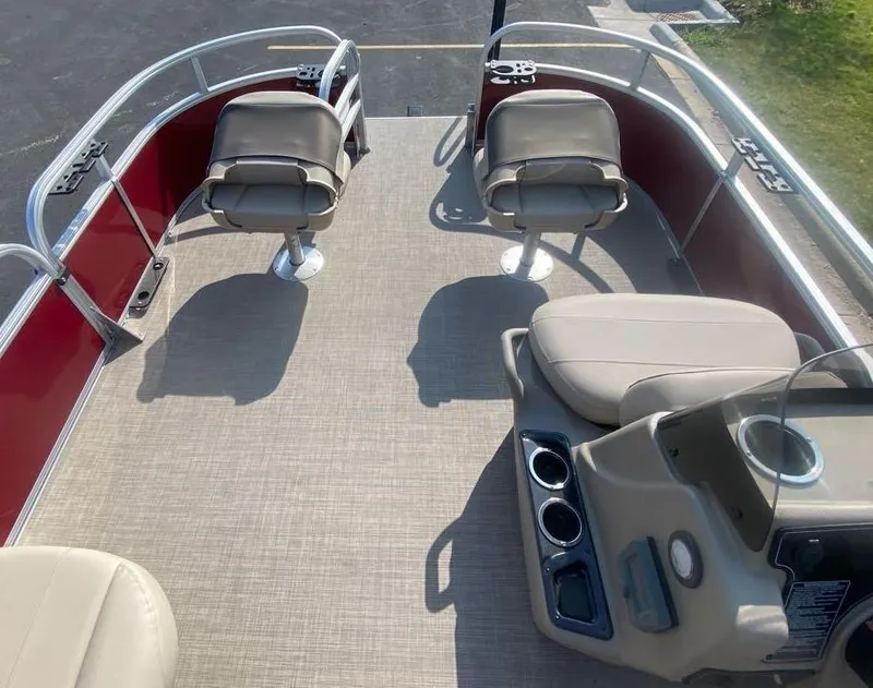 Slide: The Image of 2025 Sun Tracker Bass Buggy 16 XL Select pontoon boat interior with seating and console. - 3