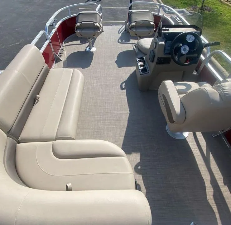 Slide: The Image of 2025 Sun Tracker Bass Buggy 16 XL Select pontoon boat interior with beige seating. - 4