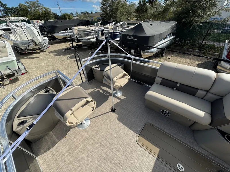 Slide: The Image of 2025 Sun Tracker Fishin' Barge 22 XP3 interior with seating and fishing setup. - 2