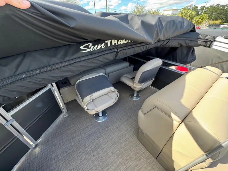 Slide: The Image of 2025 Sun Tracker Fishin' Barge 22 XP3 interior with seating and canopy. - 4