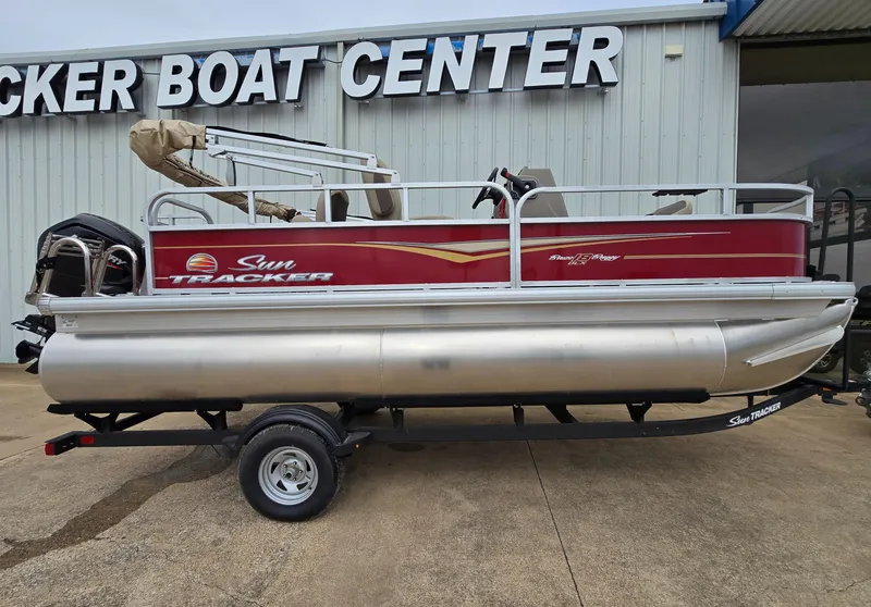Slide: The Image of 2025 Sun Tracker Bass Buggy 18 DLX pontoon boat at dealership. - 1