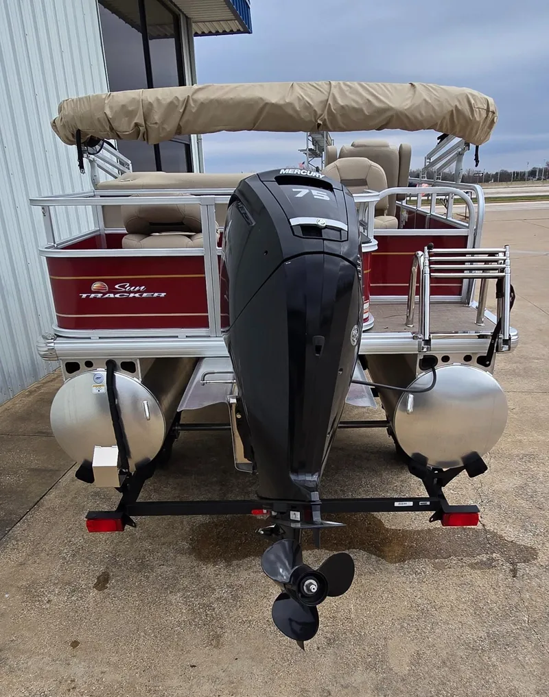 Slide: The Image of 2025 Sun Tracker Bass Buggy 18 DLX pontoon boat with outboard motor, docked on concrete. - 3