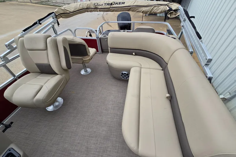 Slide: The Image of 2025 Sun Tracker Bass Buggy 18 DLX pontoon boat with beige seating and spacious deck. - 5