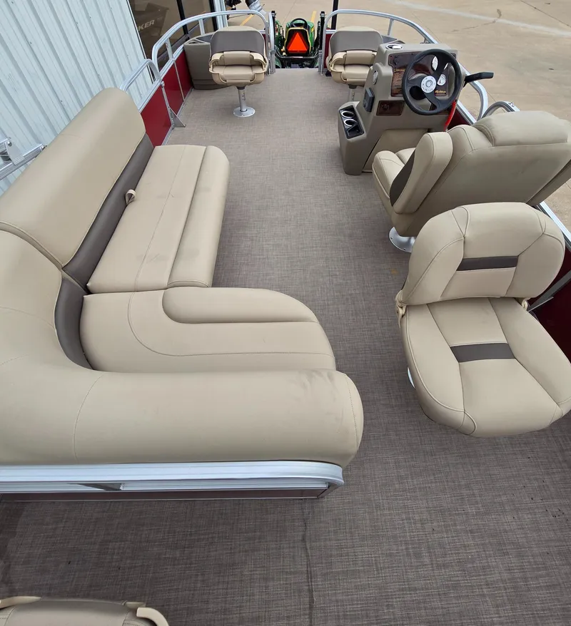 Slide: The Image of 2025 Sun Tracker Bass Buggy 18 DLX pontoon boat interior with beige seating. - 6