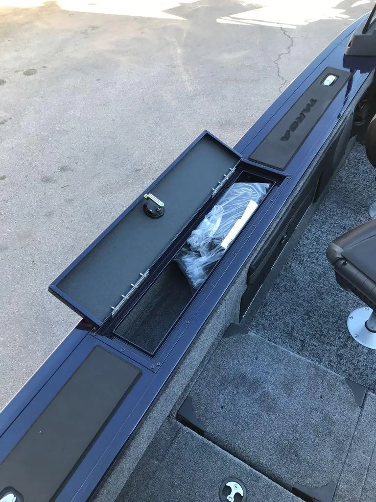 Slide: The Image of 2025 Tracker Targa V-19 Combo boat storage compartment with open lid. - 13