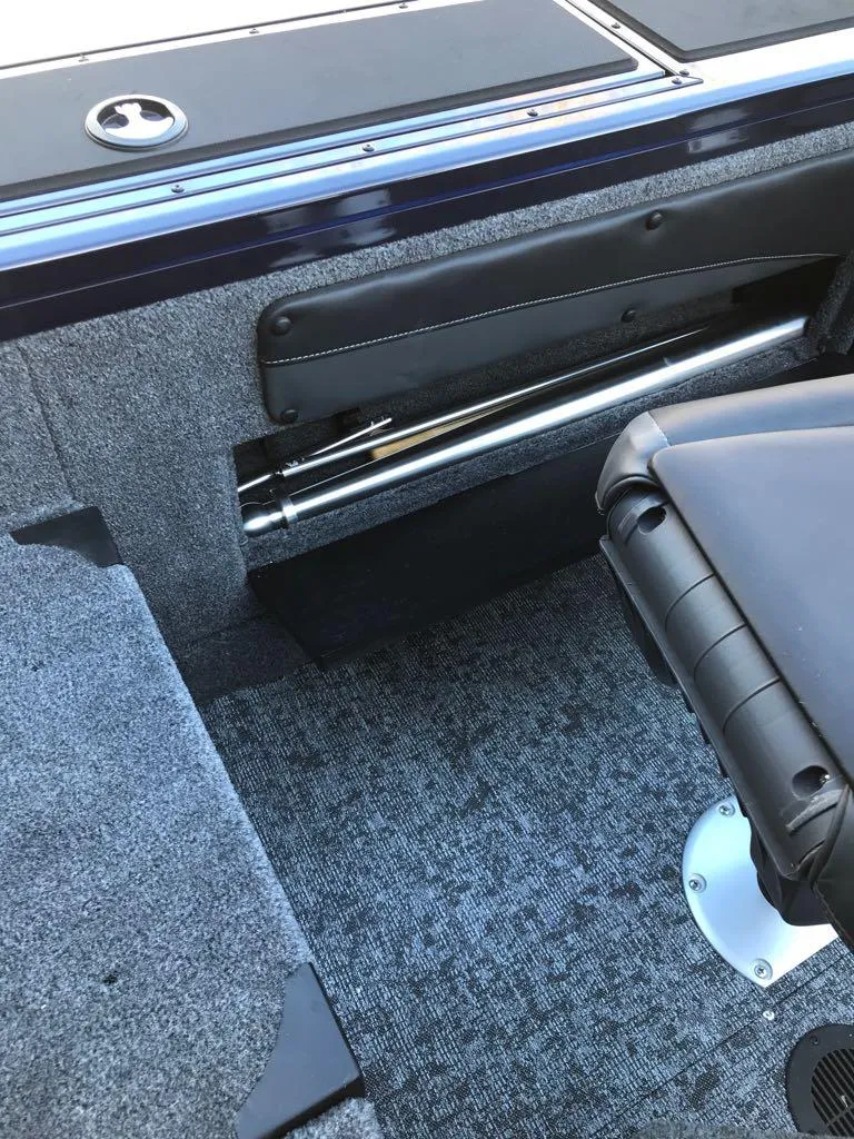 Slide: The Image of 2025 Tracker Targa V-19 Combo interior with gray carpet and seating. - 15