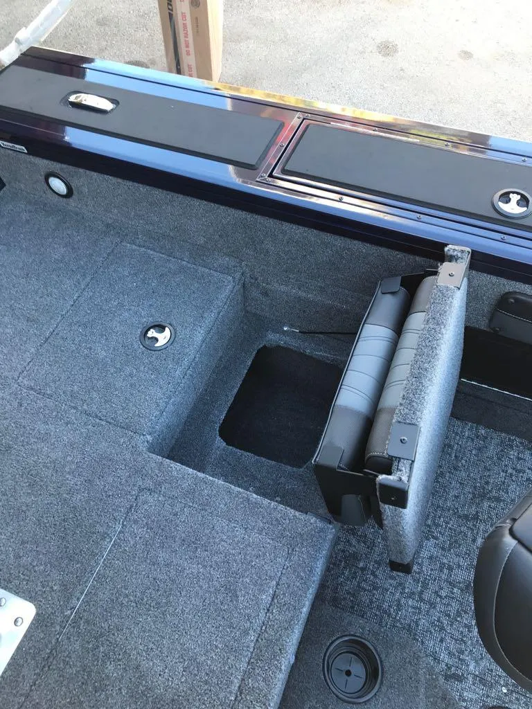 Slide: The Image of 2025 Tracker Targa V-19 Combo boat interior with foldable seat and storage. - 17