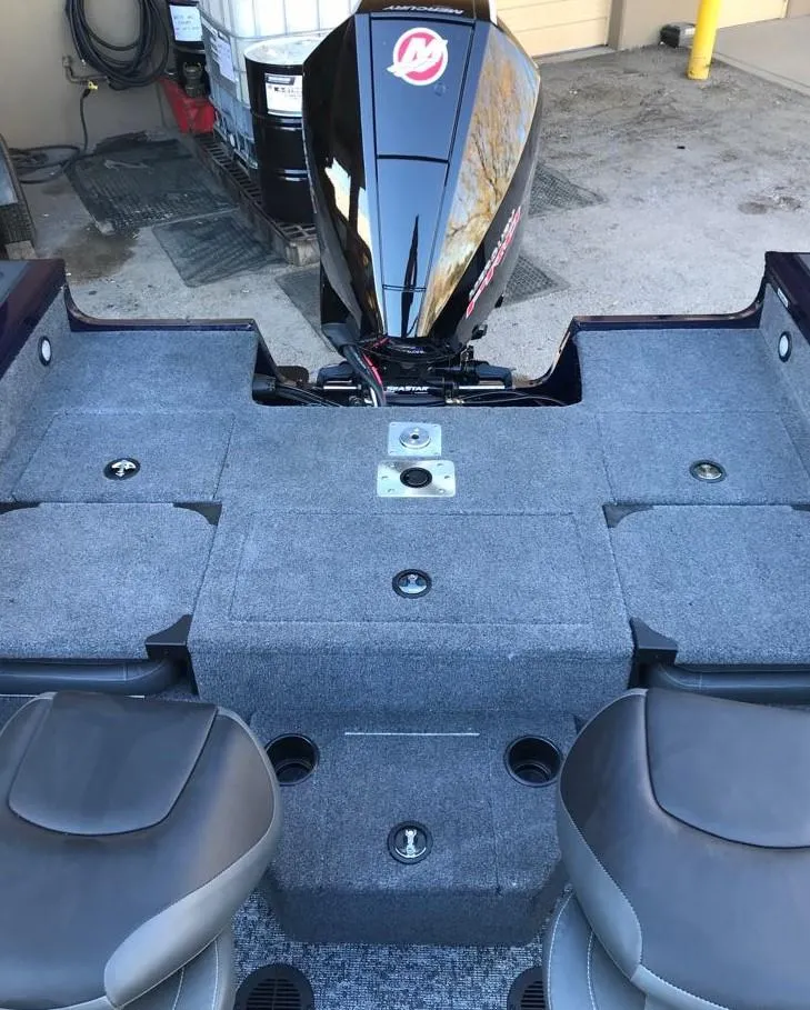 Slide: The Image of 2025 Tracker Targa V-19 Combo boat interior with seating and motor. - 18