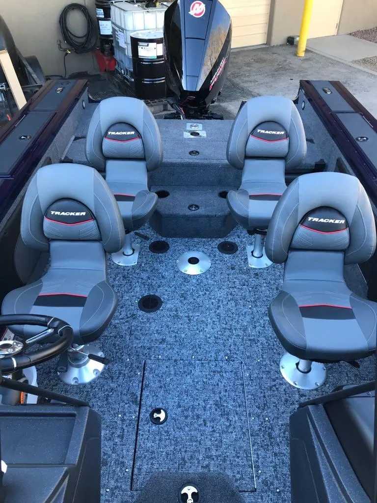 Slide: The Image of 2025 Tracker Targa V-19 Combo boat interior with four seats and carpeted flooring. - 19