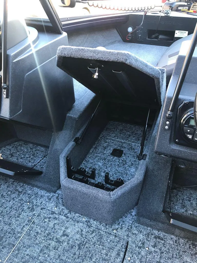 Slide: The Image of 2025 Tracker Targa V-19 Combo boat interior with open storage compartment. - 21