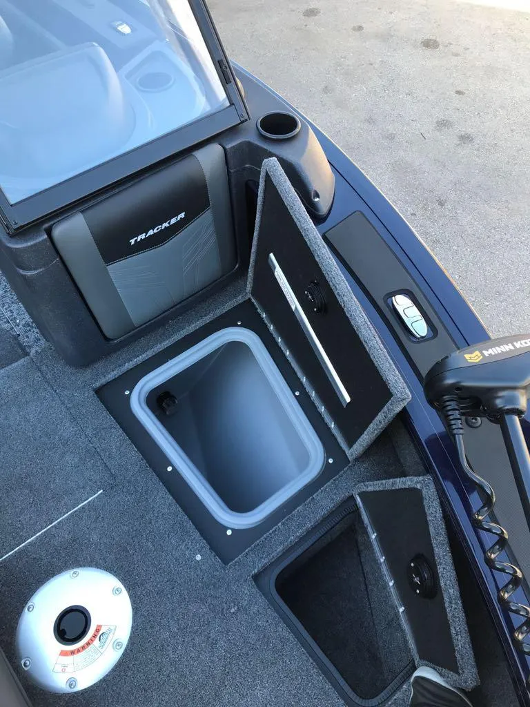 Slide: The Image of 2025 Tracker Targa V-19 Combo boat interior with storage compartments open. - 23