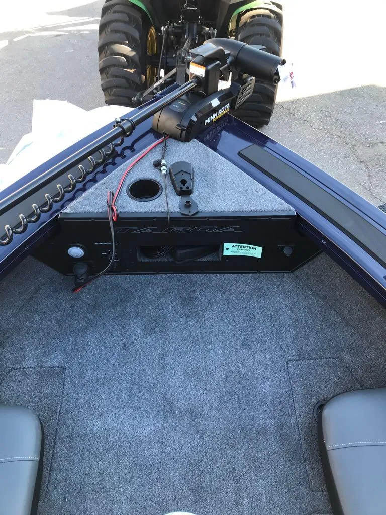 Slide: The Image of 2025 Tracker Targa V-19 Combo boat interior with trolling motor and carpeted deck. - 25
