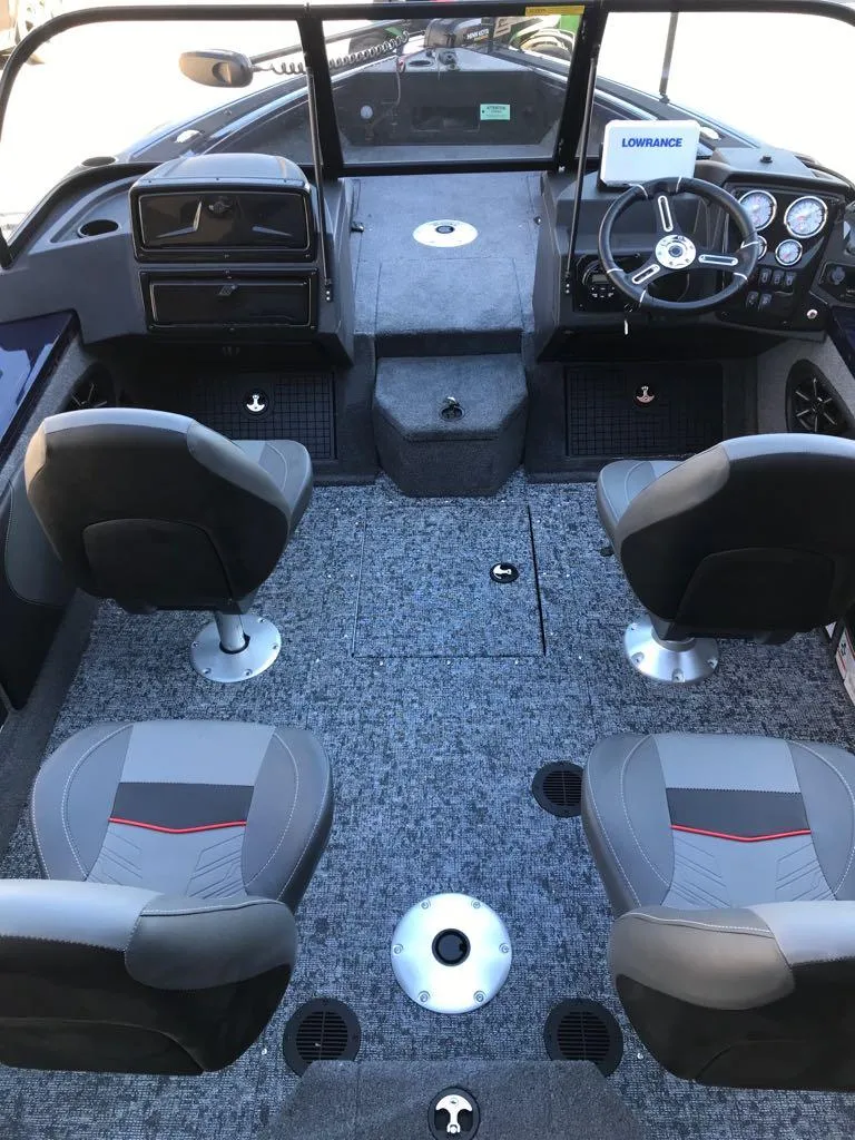 Slide: The Image of 2025 Tracker Targa V-19 Combo boat interior with four seats and steering console. - 27