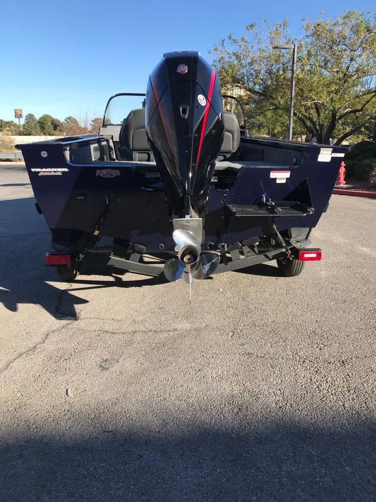 Slide: The Image of 2025 Tracker Targa V-19 Combo boat, rear view, parked outdoors. - 9