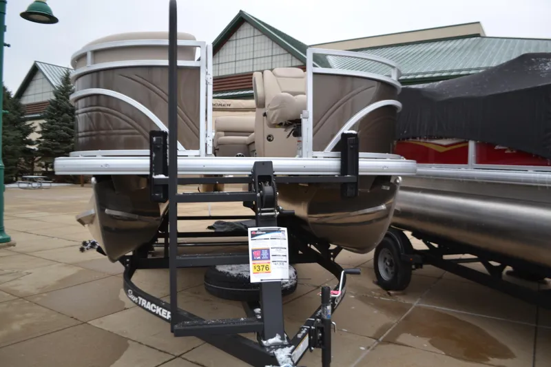 Slide: The Image of 2025 Sun Tracker SportFish 20 DLX pontoon boat on display outdoors. - 2