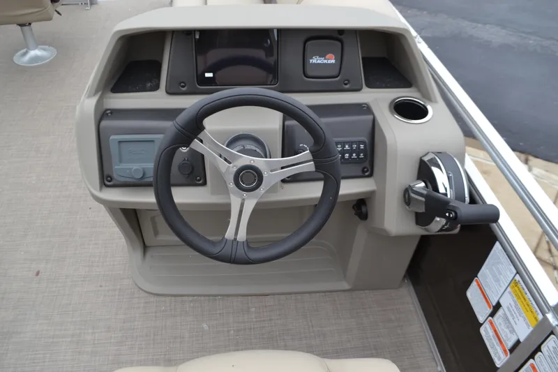 Slide: The Image of 2025 Sun Tracker SportFish 20 DLX boat console with steering wheel and controls. - 4