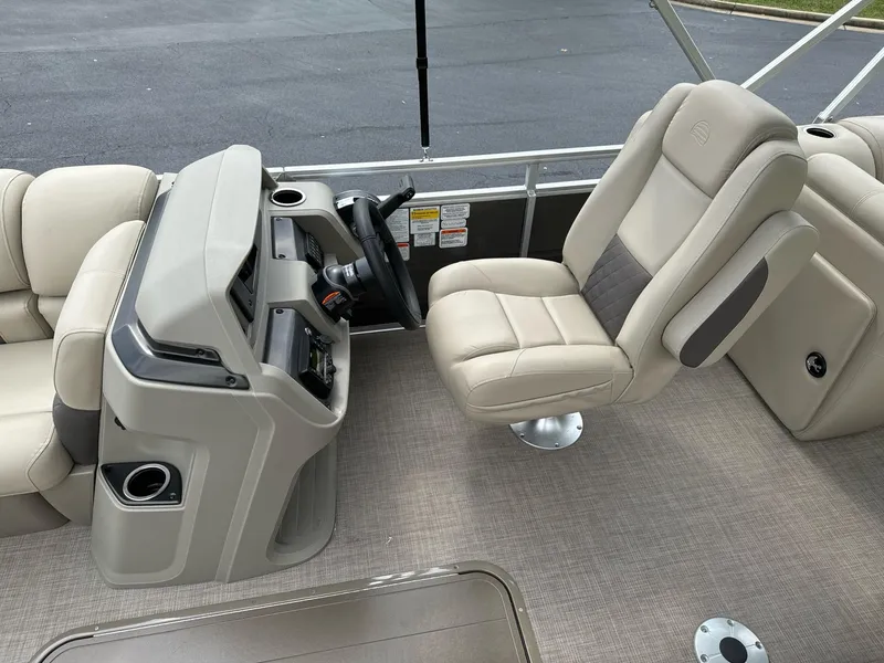 Slide: The Image of 2025 Sun Tracker Party Barge 22 RF XP3 interior with beige captain's chair and console. - 12