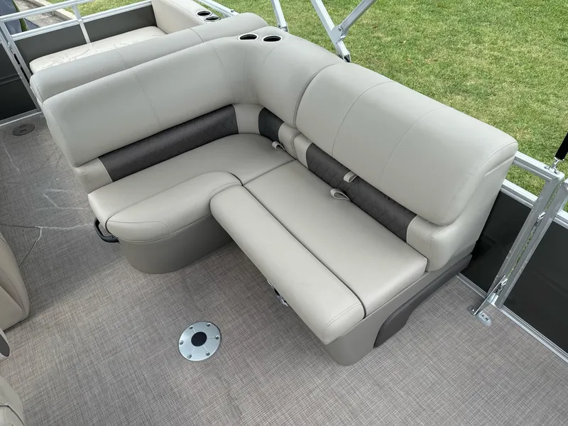 Slide: The Image of 2025 Sun Tracker Party Barge 22 RF XP3 interior seating with beige upholstery and cup holders. - 15