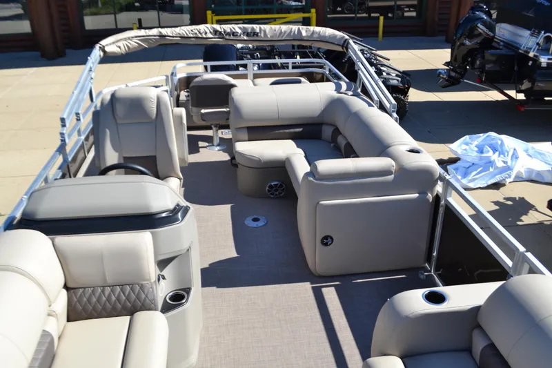 Slide: The Image of 2025 Sun Tracker SportFish 22 DLX pontoon boat with spacious seating and modern design. - 2