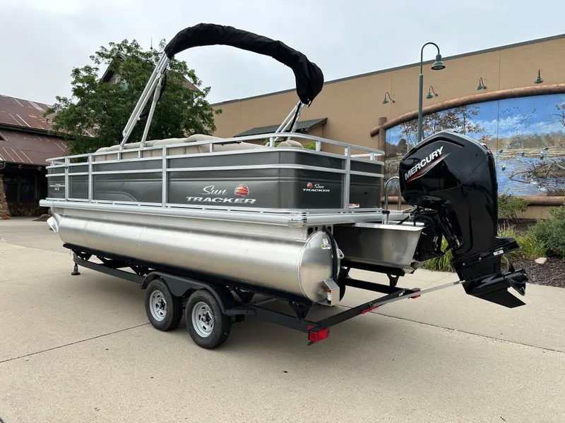 Slide: The Image of 2025 Sun Tracker Fishin' Barge 20 DLX pontoon boat with Mercury outboard motor. - 2