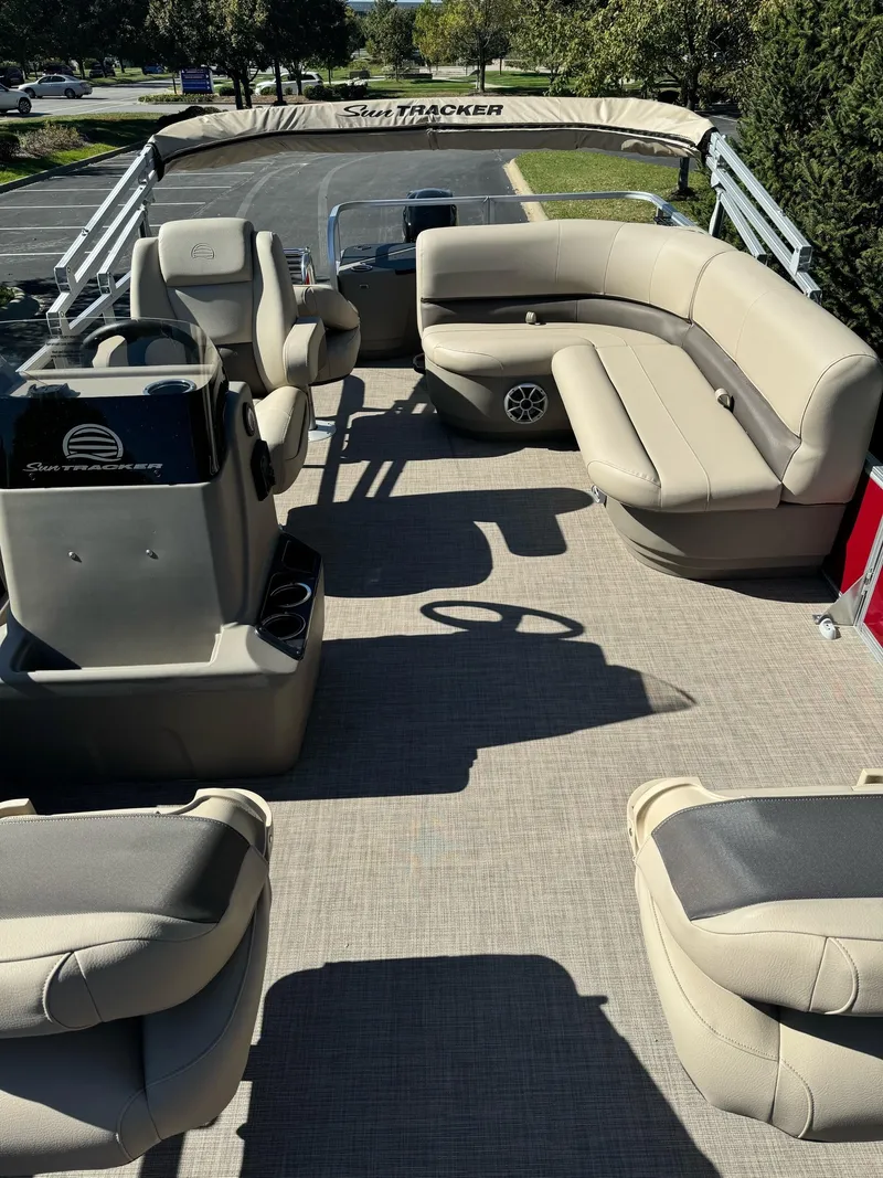 Slide: The Image of 2025 Sun Tracker Bass Buggy 18 DLX pontoon boat interior with beige seating. - 4