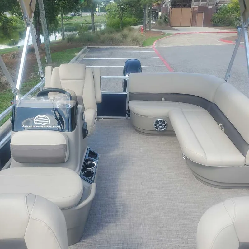 Slide: The Image of 2025 Sun Tracker Bass Buggy 16 XL Select pontoon boat interior with beige seating. - 7