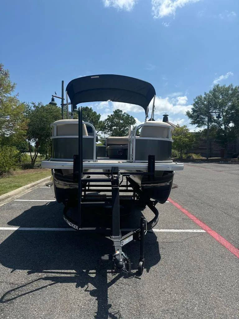 Slide: The Image of 2025 Sun Tracker Party Barge 16 DLX pontoon boat in parking lot. - 3