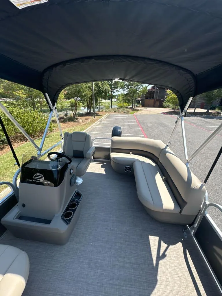 Slide: The Image of 2025 Sun Tracker Party Barge 16 DLX interior with seating and steering console. - 5
