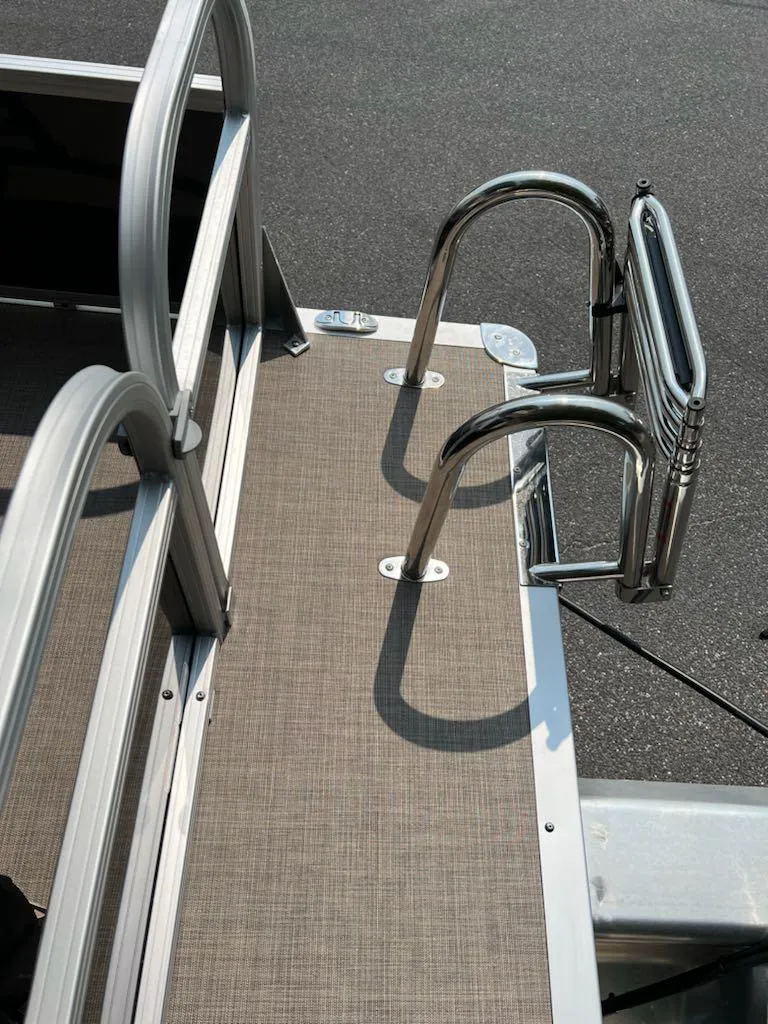Slide: The Image of 2025 Sun Tracker Party Barge 16 DLX boat ladder and deck detail. - 6