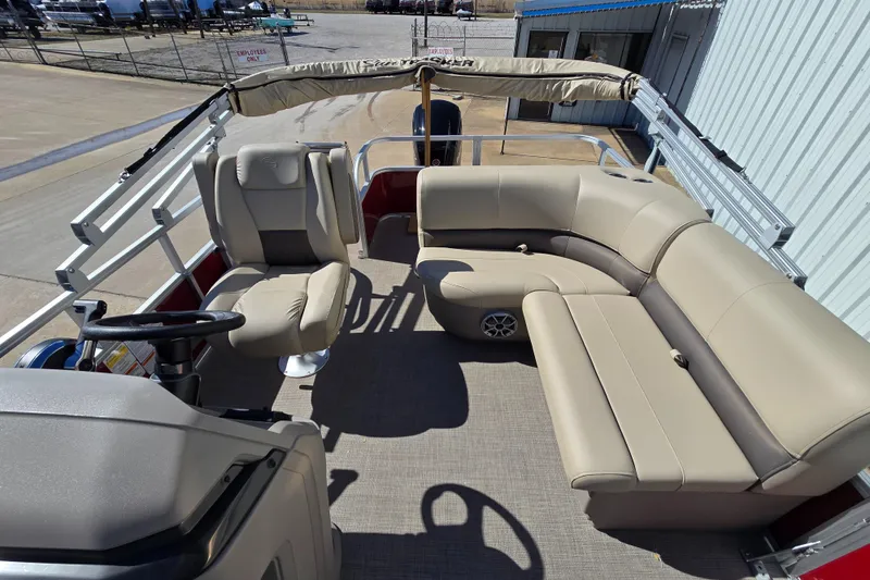 Slide: The Image of 2025 Sun Tracker Party Barge 18 DLX with beige seating and spacious deck layout. - 6