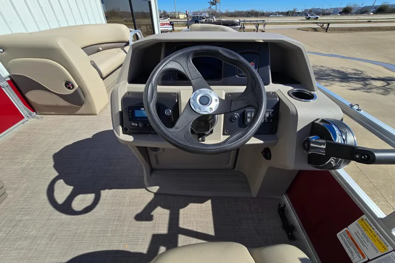 Slide: The Image of 2025 Sun Tracker Party Barge 18 DLX steering console with controls and seating. - 8