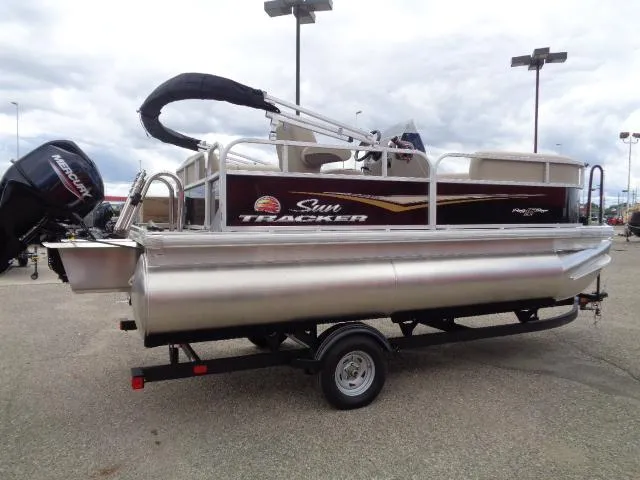 Slide: The Image of 2025 Sun Tracker Party Barge 16 DLX pontoon boat on trailer, outdoor display. - 43