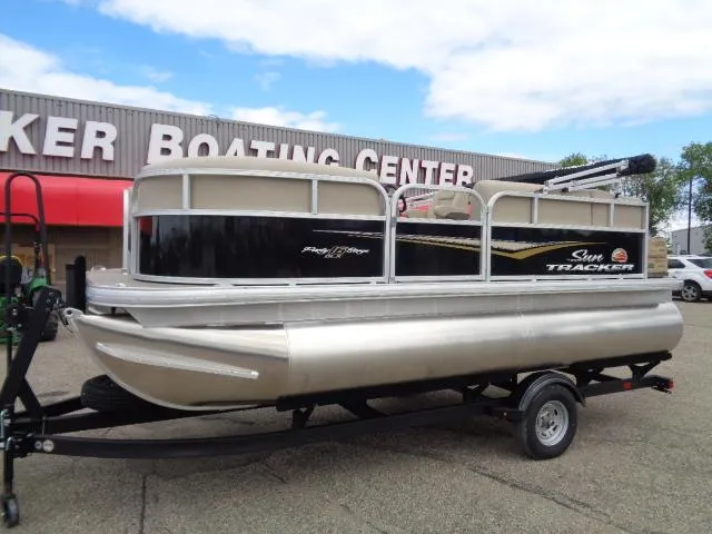 Slide: The Image of 2025 Sun Tracker Party Barge 16 DLX pontoon boat on trailer at dealership. - 45