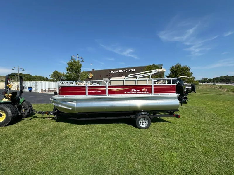 Slide: The Image of 2025 Sun Tracker Bass Buggy 18 DLX pontoon boat on grass near Tracker Boat Center. - 7
