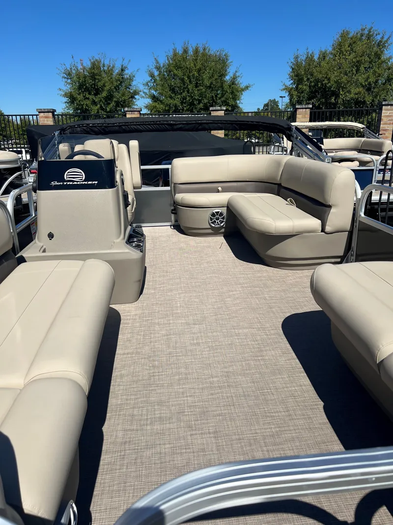 Slide: The Image of 2025 Sun Tracker Party Barge 16 DLX pontoon boat with beige seating and open deck. - 3
