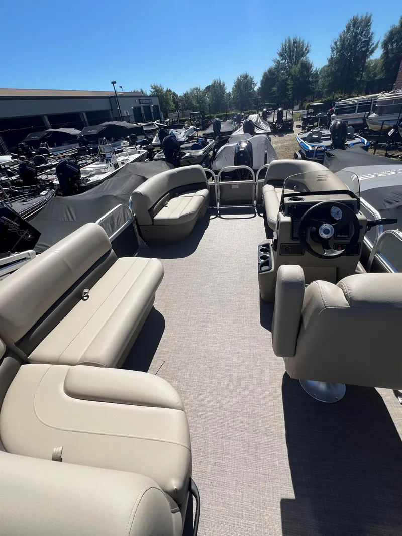 Slide: The Image of 2025 Sun Tracker Party Barge 16 DLX pontoon boat with spacious seating and steering console. - 4