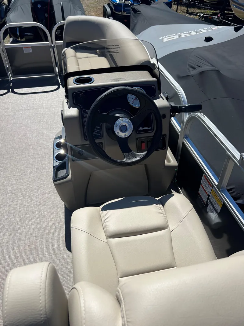 Slide: The Image of 2025 Sun Tracker Party Barge 16 DLX pontoon boat interior with steering console and seating. - 5