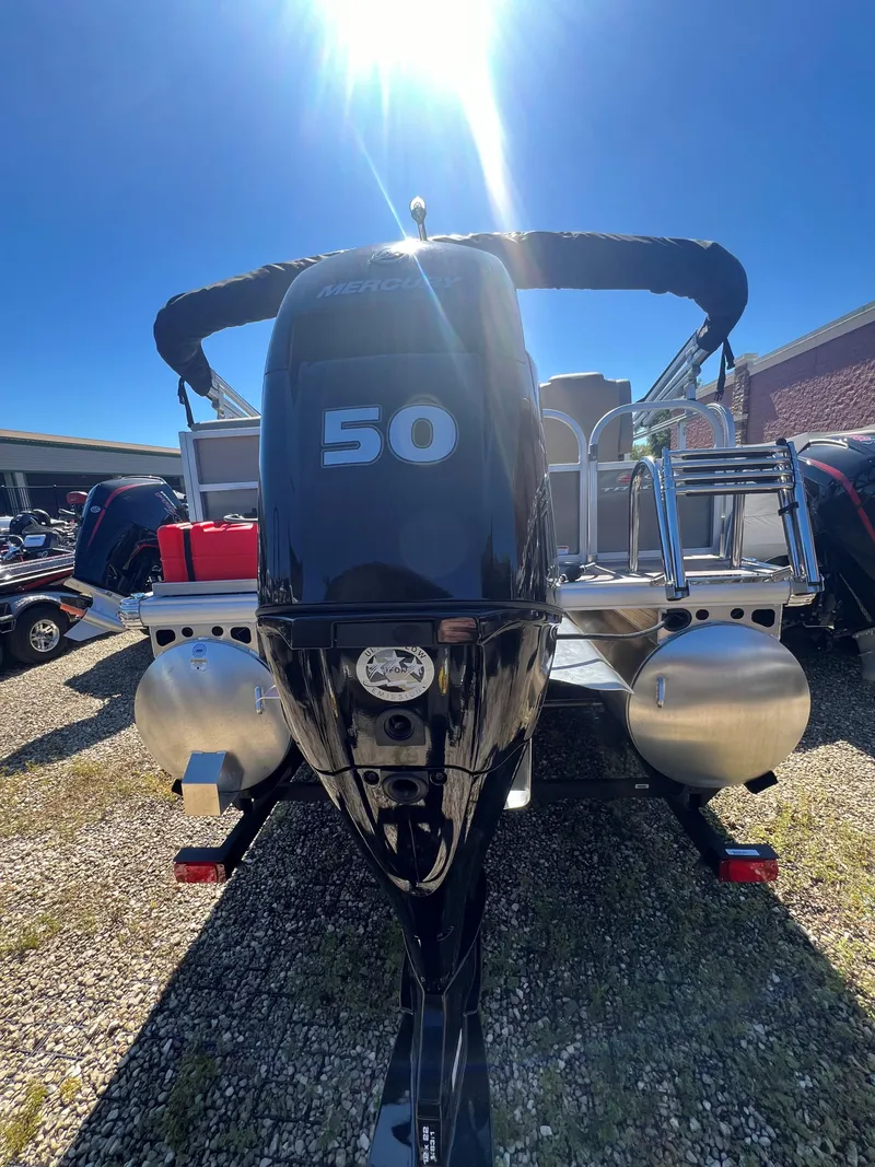 Slide: The Image of 2025 Sun Tracker Party Barge 16 DLX with 50 HP engine, parked outdoors. - 6