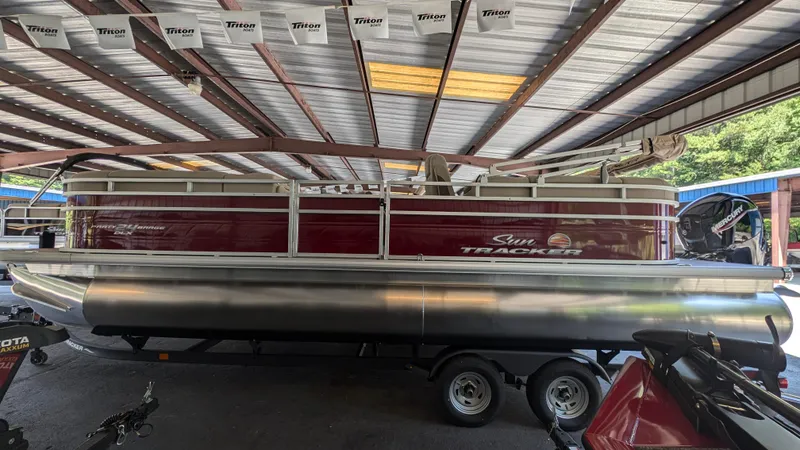 The Image of 2025 Sun Tracker Party Barge 24 DLX pontoon boat in covered storage. - 0