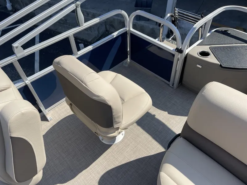 Slide: The Image of 2025 Sun Tracker Bass Buggy 18 DLX pontoon boat interior with beige seating. - 10
